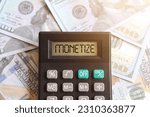 Small photo of Top view image of calculator with text MONETIZE on display and money. Content monetization concept