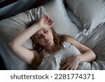 Menopausal Mature Woman Suffering With Insomnia In Bed At Home 