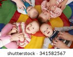 Small photo of Overhead View Of Babies Having Fun At Nursery Playgroup