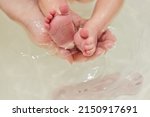 Baby feet in bath. Baby skin care.