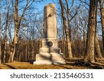 Small photo of Gettysburg, Pennsylvania, USA February 8, 2022 The 64th New York Volunteer Infantry Regiment monument on Brooke Avenue at Gettysburg National Military Park on a sunny winter day