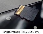 micro sd card lies on the smartphone screen. close-up