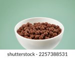 Bowl with chocolate balls. dry breakfast. crunchy corn balls with cocoa on color background. High quality 4k footage