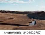Small photo of View of the upper oldman river running through the nearly empty Oldman Reservoir in Alberta, Canada