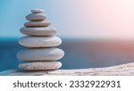 Small photo of Balanced rock pyramid on sea pebbles beach, sunny day and clear sky at sunset. Golden sea bokeh on background. Selective focus, zen stones on sea beach, meditation, spa, harmony, calm, balance concept