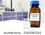 Small photo of Selective focus of propylene glycol liquid chemical compound in dark glass bottle inside a chemistry laboratory with copy space.