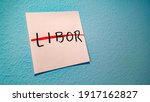 Small photo of LIBOR (abbreviation for London Interbank Offered Rate) on a sticky note, crossed out with a red pen