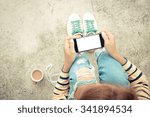 woman holding phone white screen on top view vintage style