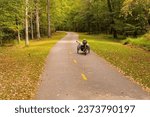 Small photo of Raleigh, North Carolina USA-10 11 2023: A Recumbent Three Wheel Bicycle Travels Down the Neuse River Greenway.