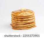 Pancakes stack with melting butter piece and pouring honey. Close up view. Wite background. Maslenitsa concept. Crepes week. Delicious homemadу breakfast or lunch.
