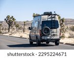 Small photo of Joshua Tree National Park CA USA Feb 19, 2023 A Winnebago Mercedes Sprinter Van drives through on a sunny day