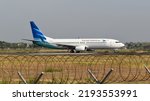 Small photo of Boyolali, Central Java, Indonesia-October 12, 2019: Garuda Indonesia, PK-GFQ, Boeing 737-800. backtrack taxi to runway 26 of Adi Soemarmo Airport for take off