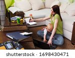 Working mom with baby in her chaotic home office