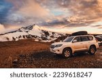4x4 vehicle car parked with volcanic mountain and sunset sky among the Icelandic Highlands on summer at Kerlingarfjoll, Iceland