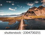 Aerial view landscape of Vestrahorn mountain with dirt road on black sand beach in Atlantic ocean on Stokksnes peninsula at Iceland