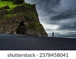 Dramatic landscape of Halsanefshellir cave with Reynisdrangar natural rock formation on Reynisfjara black sand beach in gloomy day during summer at South of Iceland