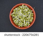 sprouted mung beans in a brown bowl 