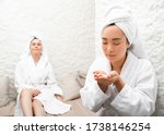 Beautiful woman and her girlfriend inhales the salt air, halotherapy. Salt air treatment at the spa