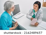 Small photo of Positive doctor consulting senior woman on results of cardiogram and test. Diagnostic heart diseases, heart attacks, and tachycardia in elderly people