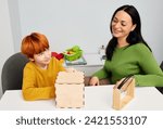 Small photo of Child development specialist woman working with child with autism spectrum disorder. Play-based therapy