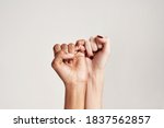 Small photo of Close up of two female hands making a pinkie promise sign isolated over grey background. The symbol of commitment. Selective focus. Horizontal shot