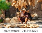 Small photo of Fish trap village wicker craftsman making traditional bamboo fish trap weaving from bamboo strips at the old house in Thu sy trade village, Hung Yen, Vietnam traditional artist, travel concept