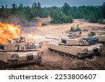 Small photo of ADAZI, LATVIA, JUNE 2016 - U.S. M1 Abrams tanks fire during the "Saber Strike" NATO military exercise