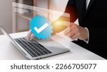 Small photo of Businessman using laptop with verification account blue tick checkmark concept, verification account on social media platform, subscription status, eliminate bots, spam.