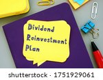 Business concept meaning Dividend Reinvestment Plan DRIP with sign on the sheet.
