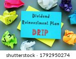 Financial concept about Dividend Reinvestment Plan DRIP with sign on the page.