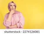 Muslim woman with hand on face and thoughtful expression