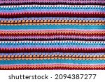 Crochet texture of colored striped knitted fabric