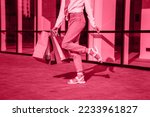 Viva Meganta toned red magenta european woman hold bags after shopping, retail store mall on the street sales black friday season. Trendy color of the year 2023. Fashion color pattern

