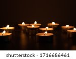 Small photo of Religious and devoutness scene: candles burning in the dark