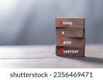 Small photo of LIFE living in faith everyday symbol. Concept words LIFE living in faith everyday on wooden blocks on beautiful wooden background. Business LIFE living in faith everyday concept. Copy space.