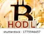 hodl btc concept. wooden blocks with hodl inscription with bitcoin on the background