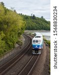 Small photo of Seattle, WA / USA - 19 May 2017: A Sound Transit train passes under the pedestrian overpass at Carkeek Park