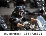 Brutal biker with skeleton mask. unidentified motorcycle rider in a mask takes part in a motorcycle parade          