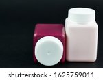Groupe of cosmetic bottles at black background