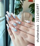 Small photo of Pretty cloudy twinge nail art on acrylic nails set pink white blue, manicured nails