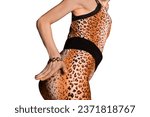 Small photo of Thin young girl in leopard pattern suit posing and seducing, attracting attention with her hand on a white isolated background.
