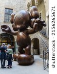 Small photo of Barcelona, Spain - April 16, 2022. Moco Museum of Barcelona entrance with a statue of Brian Donnelly, known professionally as KAWS, is an artist and designer of limited edition toys and costumes.