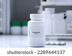 Small photo of Prednisone pill in white bottle, pill stock, medical or pharmacy concept