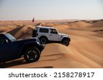 Small photo of 4x4 vehicles dune bashing in Sharqiya Sands desert in Oman. 26 November 2021.