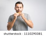 Young man holding a piece of hamburger. Student eats fast food. Hot helpful food. very hungry guy. Diet concept. 
