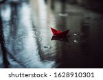 Red Paper Boat In The Rain