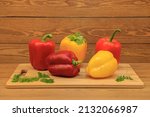 Beautiful vegetables with red pepper. Bulgarian red pepper .and green pepper on a cutting board, for a festive table. Sliced vegetable salad. close-up.Still-life. wooden background.