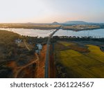drone shot aerial view top angle bright sunny day terrain landscape wallpaper background india tamilnadu tourism scenery agricultural fields cultivation lake turquoise blue water railway track sunset 