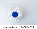 crumpled pet bottle on top of a white background