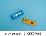 Small photo of A coloured wooden block with word “TRUE, FALSE” on it